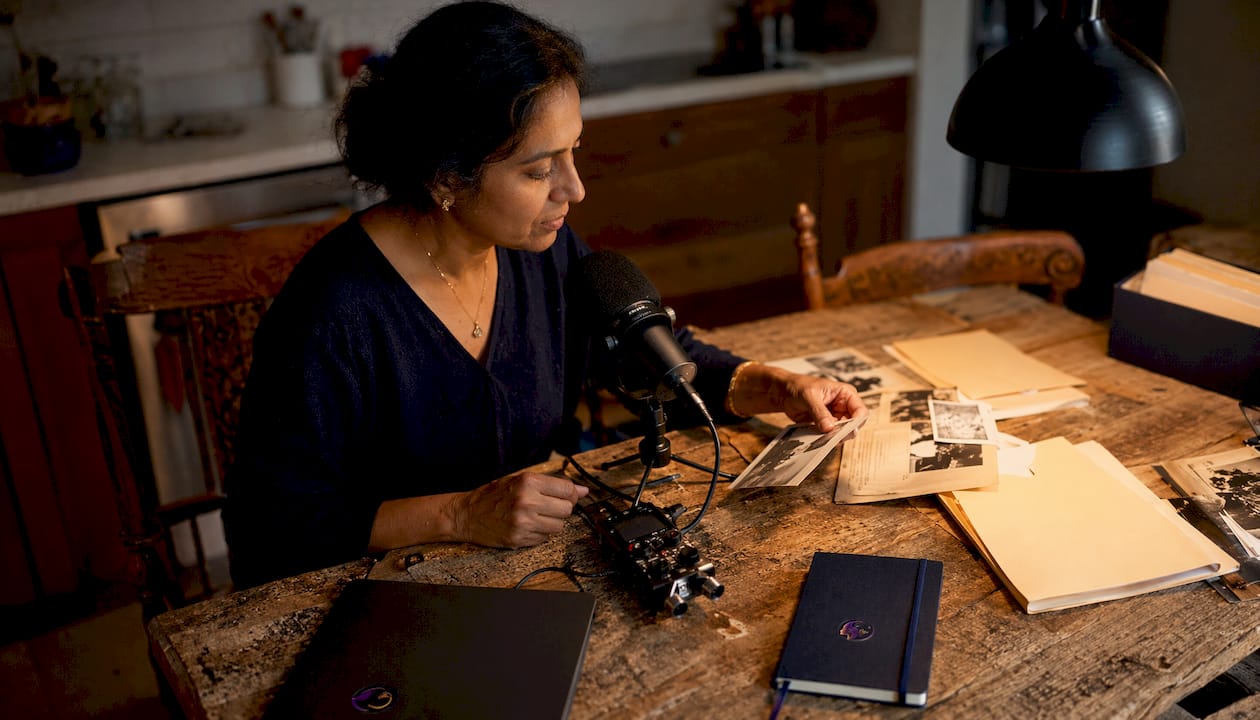 Woman recording family voice archive at home desk