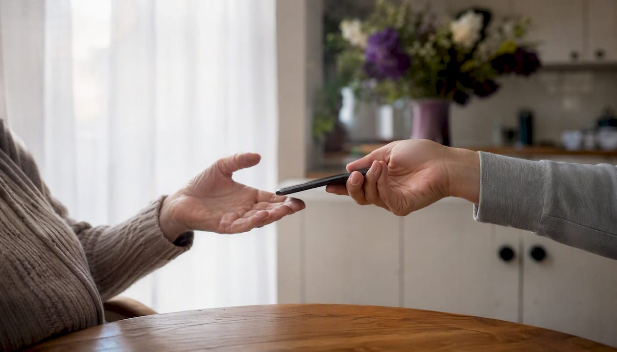 Passing smartphone to senior parent gently