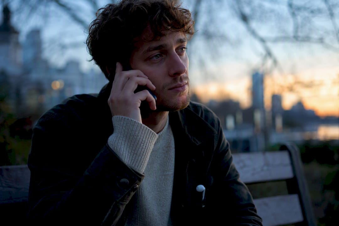 Person quietly listening to pet memory outdoors
